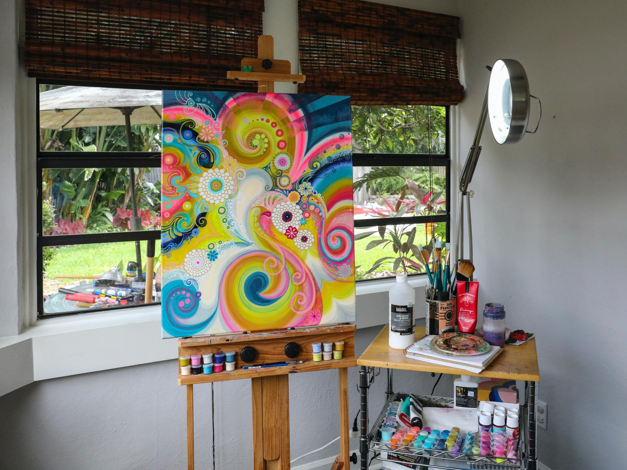 An abstract, bright painting on canvas in an amateur artist studio